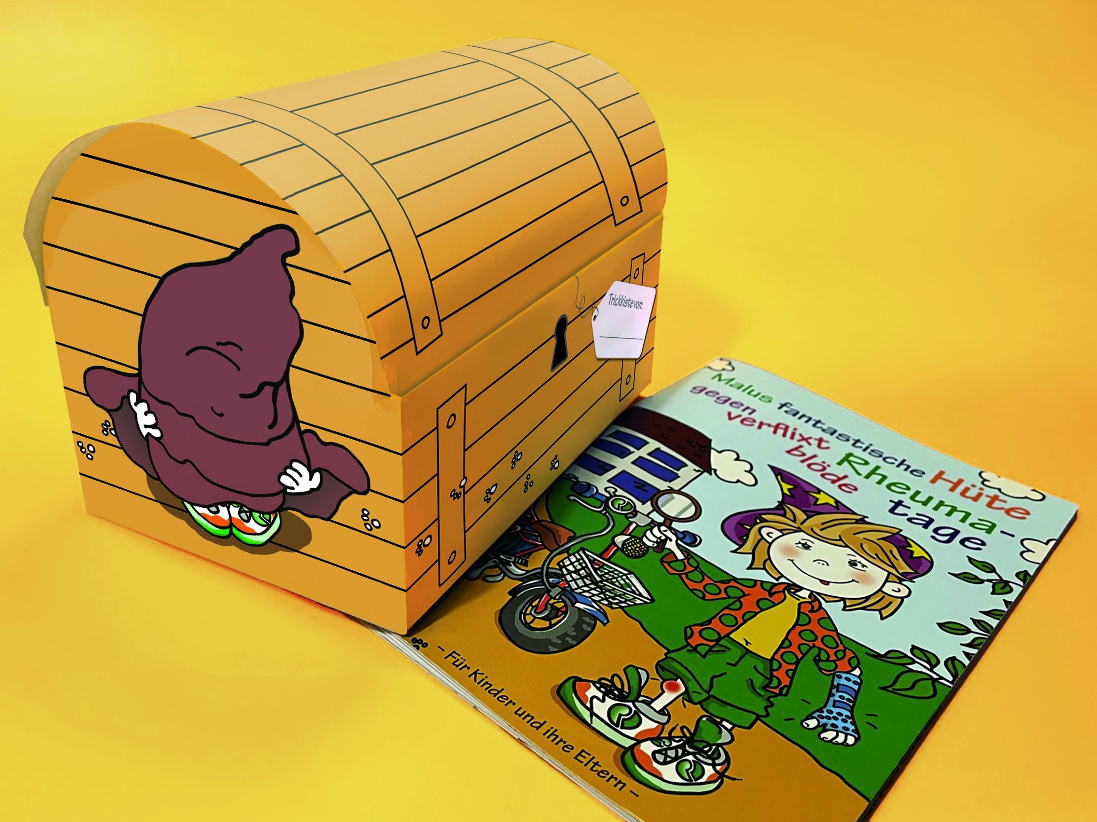 Das Kinderbuch Malu liegt neben der Trickkiste für Kinder.,